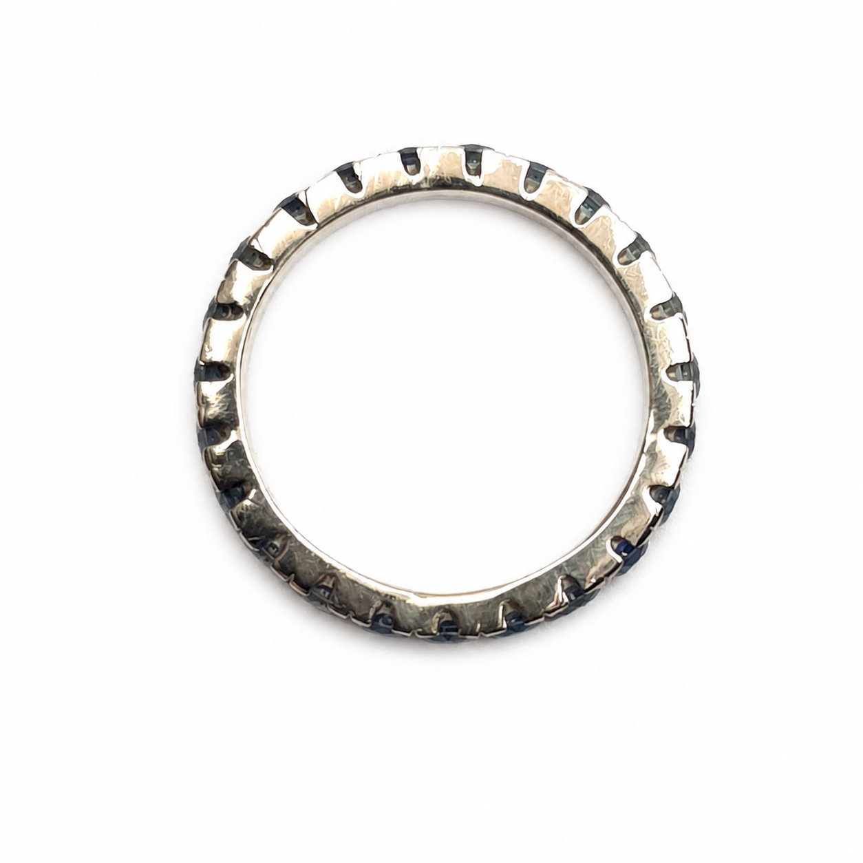 Handmade 14K yellow gold eternity band featuring 2.30 carats of blue Montana sapphires arranged in a continuous colour gradient.