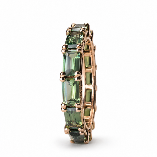 Green and teal sapphire eternity band featuring 5.09 carats of sapphires set continuously in 14K rose gold.