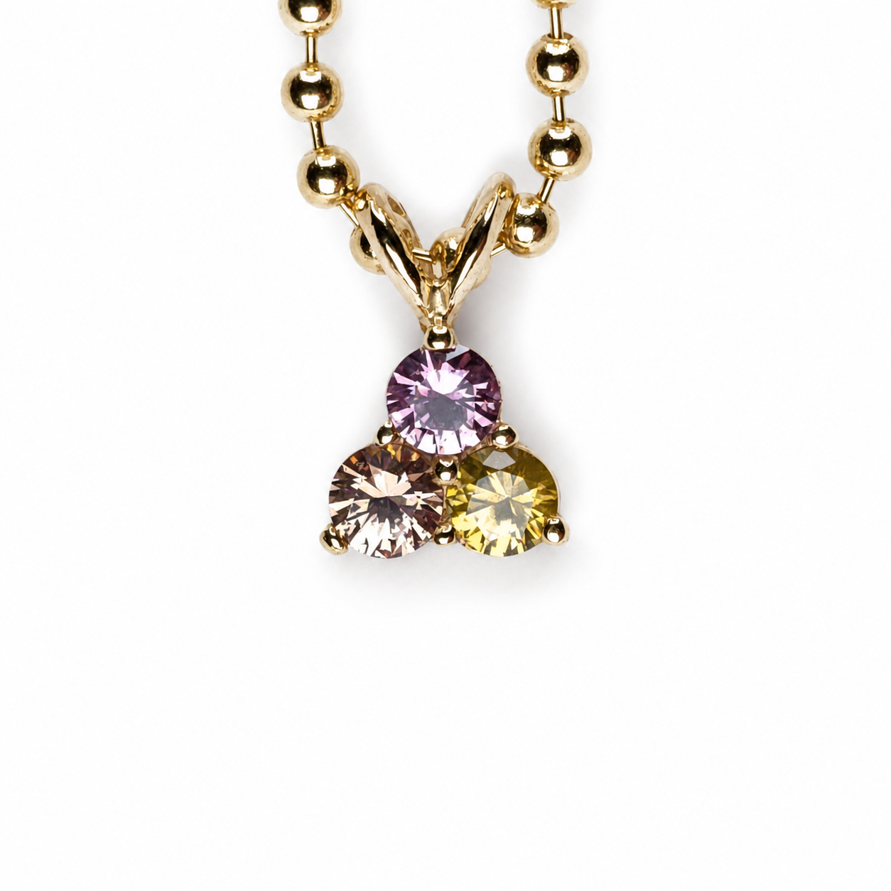 Trillium pendant featuring three multicolour Thai-cut sapphires totalling 0.54 carats, hand-set in 14K yellow gold; chain not included.