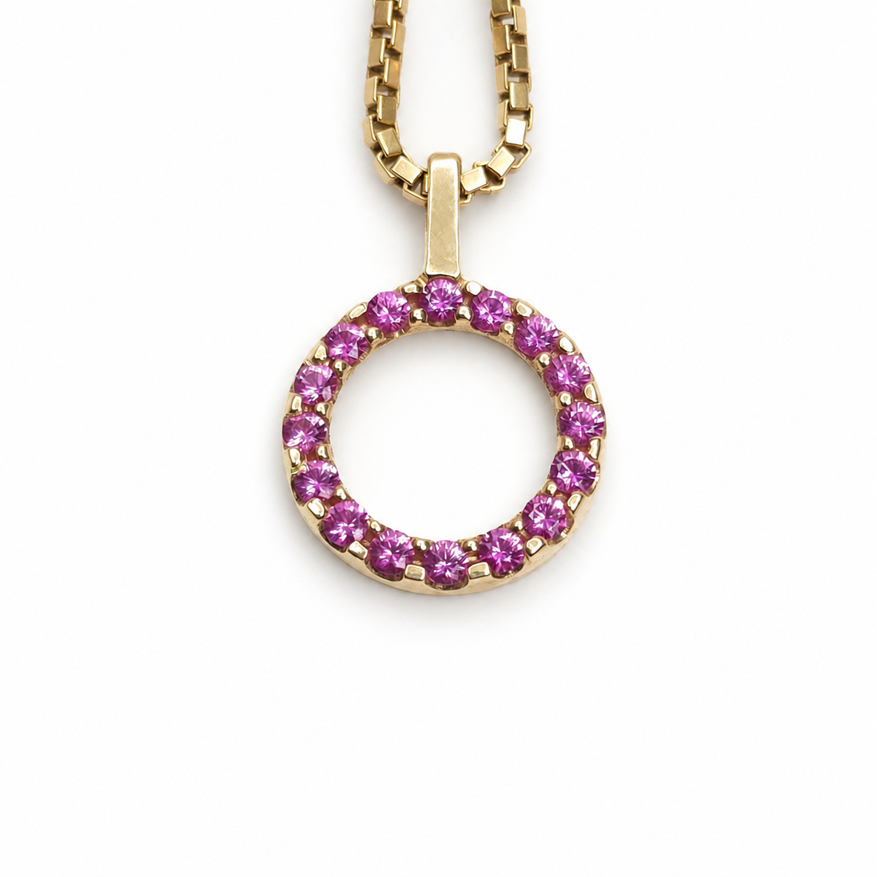 Ruby eternity circle pendant featuring 0.51 total carats of round rubies set in polished 14K yellow gold
