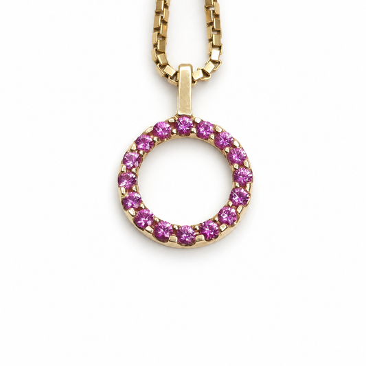 Ruby eternity circle pendant featuring 0.51 total carats of round rubies set in polished 14K yellow gold