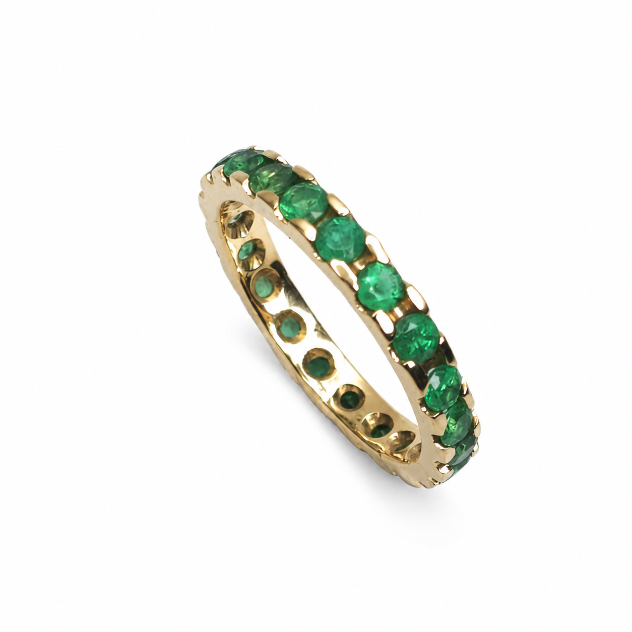 Full eternity band featuring 0.93 carats of round Colombian emeralds in a shared-prong 14K yellow gold setting.