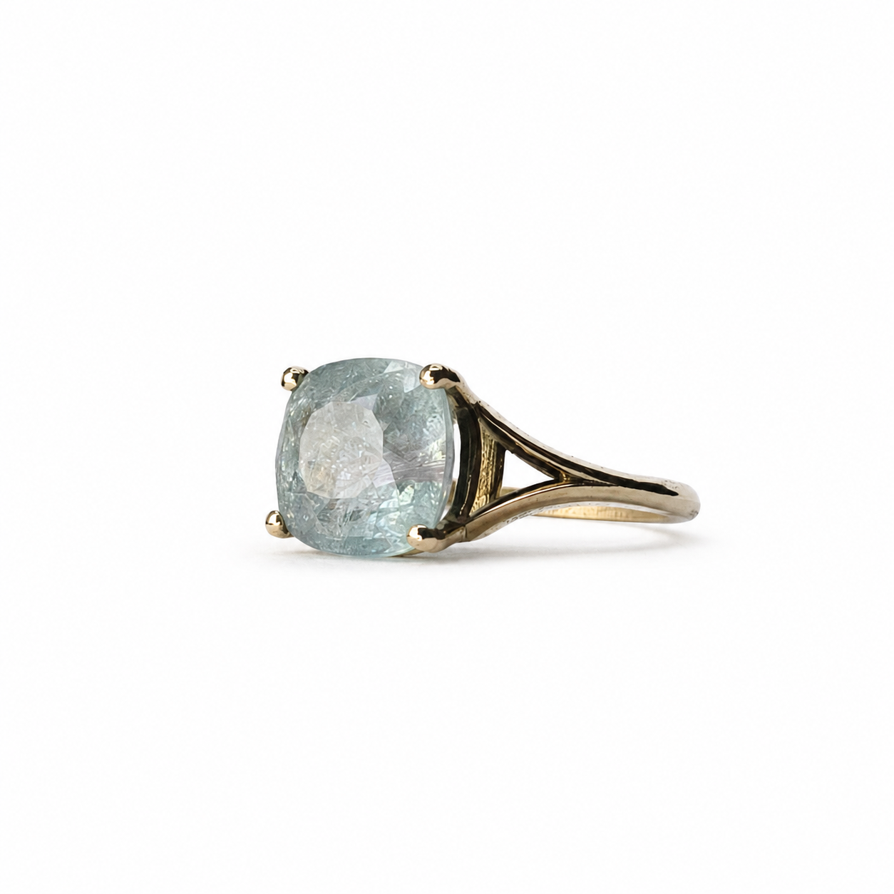 The Eye of Paraíba ring featuring a certified 4.43 carat ice-blue Paraíba tourmaline in a sculpted 14K yellow gold setting.