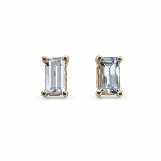 Pair of baguette step-cut white sapphire stud earrings totalling 0.75 carats, set in polished 14K yellow gold.
