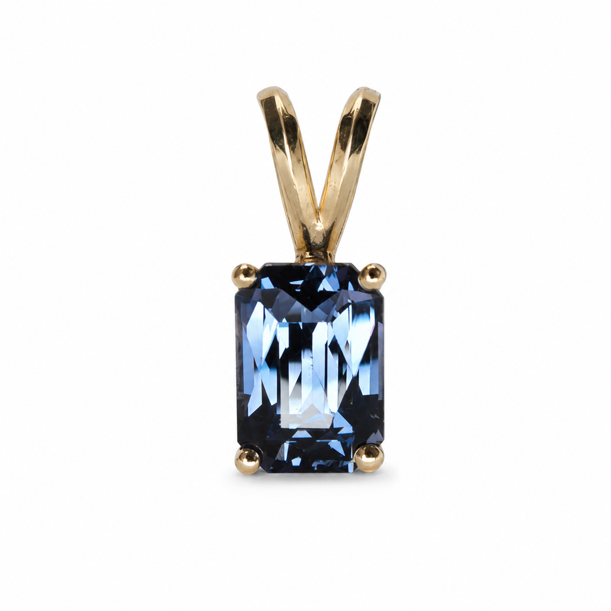 14k Yellow gold pendant featuring a certified 1.54 carat natural blue spinel with an octagonal mixed cut and four-prong setting.