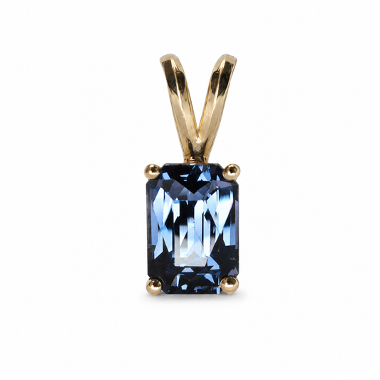 14k Yellow gold pendant featuring a certified 1.54 carat natural blue spinel with an octagonal mixed cut and four-prong setting.