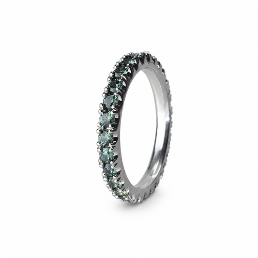 Platinum full eternity band featuring 1.08 carats of round Montana sapphires arranged in a continuous teal-green gradient.